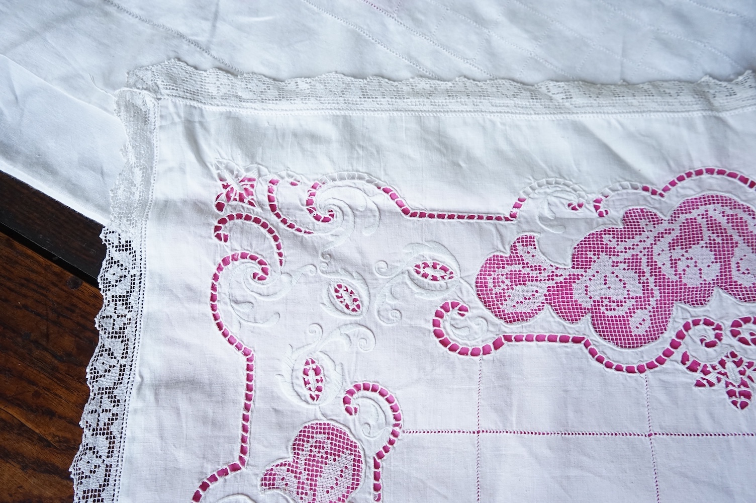 A late 19th century early 20th century finely woven, hand worked linen sheet 6’8”wide, together with a near matching large square pillowcase. Both items worked in Embroidery Anglaise, button holed and inset and trimmed w